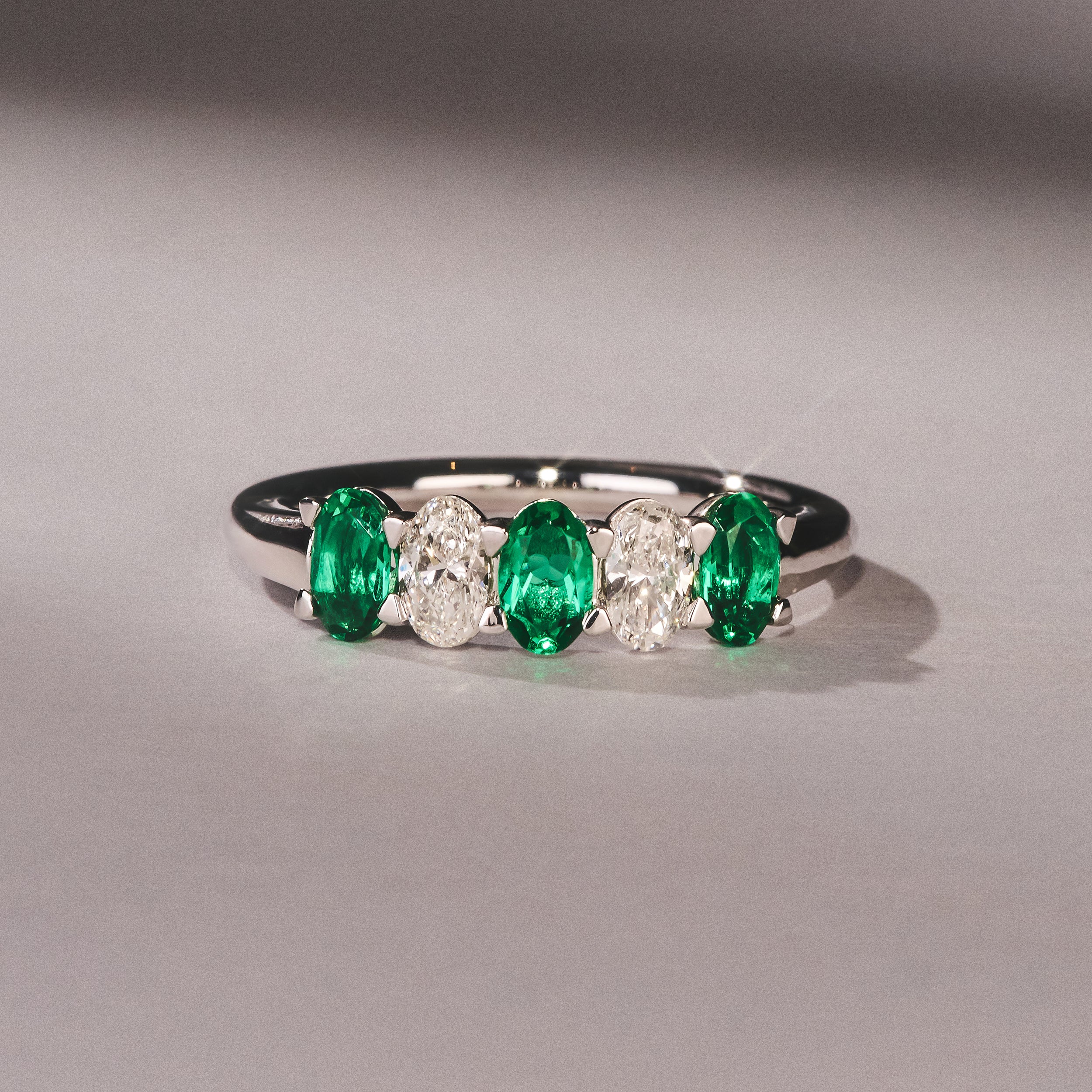 Solene 0.75ct Oval Cut Lab Emerald and Lab Diamond Half Band Eternity Ring in 18K White Gold - Image 6