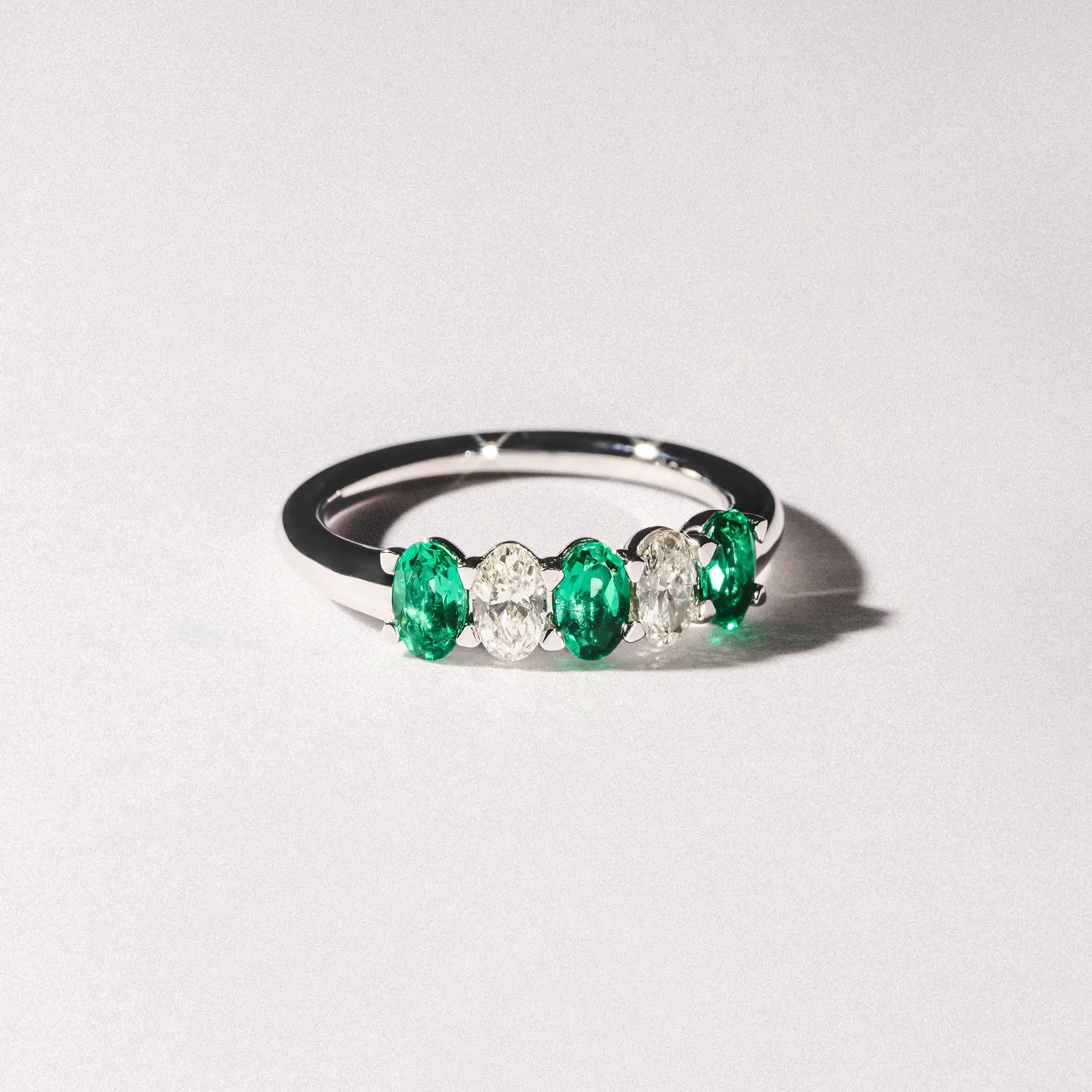 Solene 0.75ct Oval Cut Lab Emerald and Lab Diamond Half Band Eternity Ring in 18K White Gold - Image 8